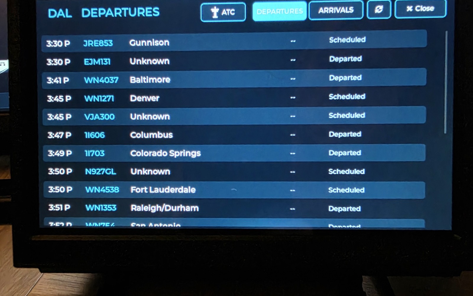 WingsAbove Dallas Love Field departures board with live flight numbers, destinations, times and statuses